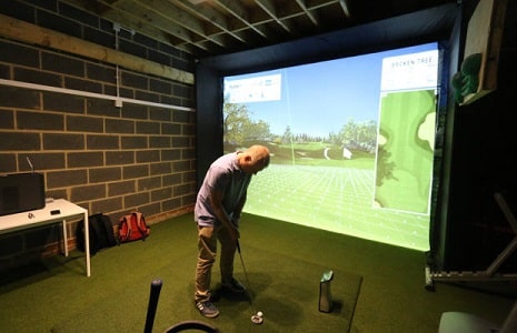 Golf simulator set up in a garage